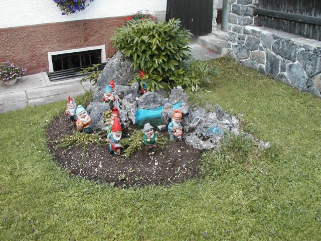 Garden gnomes in front of a house in Reutte-in-Tirol.  We spotted
these on the walk back from the Ehrenberg ruins.  Garden gnomes are
very popular in Germany, but most people have only a couple.  Photo by
Pat.