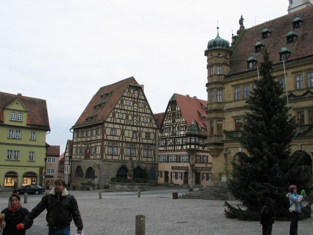 The Rothenburg Marktplatz, with the Christmas tree still standing. The Rathaus is on the right.  Note the medieval architecture of the surrounding buildings.  The houses had very large attics because there was a city requirement that you be able to store a year's worth of grain in case of siege (which happened to Rothenburg a LOT!).
