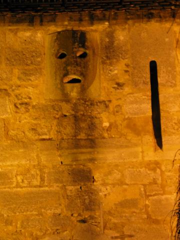 A mask in the Rothenburg wall.  The black line on the right is an archer's port; the mask itself has holes that were used to pour boiling oil on anyone who tried to break down the gate directly below.