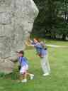 Pat and Xandie prop up a stone in the Avebury circle.