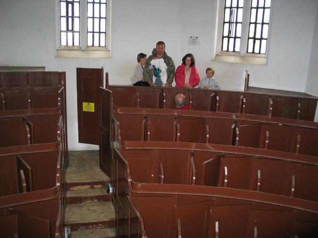 Inside the prisoners' chapel at Lincoln Castle.  Each of the booths
has its own door, constructed so that when someone is in the next
booth, you can't get out.  The corridor door locks.  The booths are
designed so that you can't really sit down, and the preacher can see
whether everyone is paying attention.  Pat and I briefly got locked in
when one of the latches jammed!