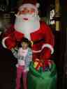 Xandie and an inflatable Santa at an indoor "Spielpark" (playpark).