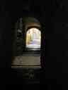 A Moorish-influenced passageway leads to sunlight in Girona.