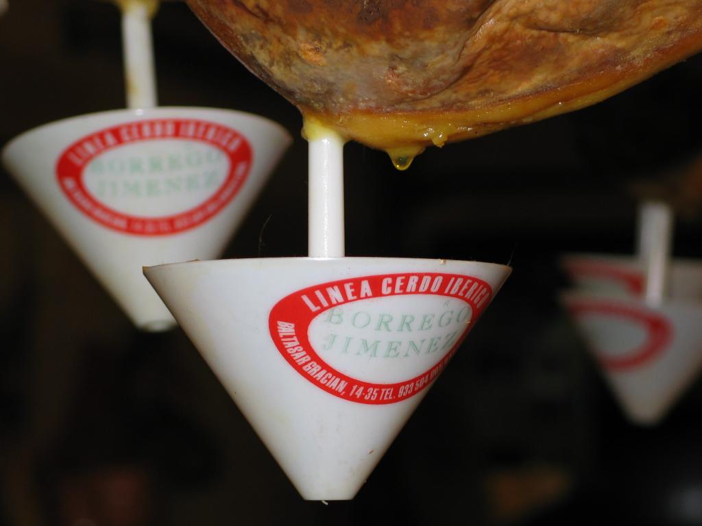 Fat drips off ham hocks at a Barcelona restaurant.