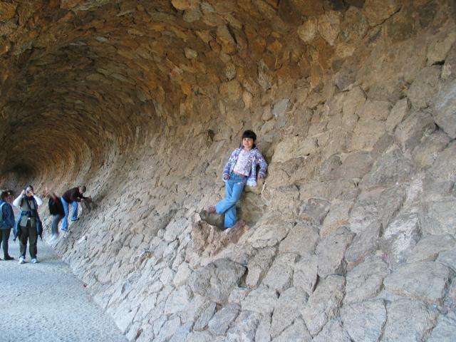Xandie after climbing the wall in a very odd passageway in Parc Guell.  Pat can be seen photographing her (and me).