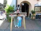 Pat and Xandie are punished in the stocks outside our hotel in
Fssen.  (Both have hands so small that they could insert them
without lifting the upper bar.)