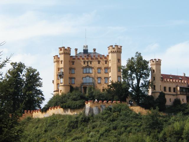 Hohenschwangau Castle, where "Mad" King Ludwig II grew up,
photographed from the path to Neuschwanstein Castle, which Ludwig
built to use as his primary residence but lived in for only about 70
days before his untimely death.  Photo by Xandie.