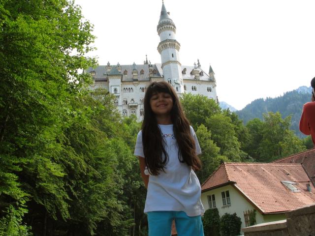 Xandie in front of Neuschwanstein castle.  There is still a pretty
good climb to get to the start of the tour, but we stopped here to get
a few pictures.  (Color-adjusted: ggamma = 0.9, bgamma = 0.8.)