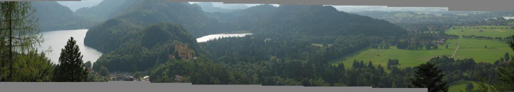 A panoramic view of the valley around Neuschwanstein Castle.  This
picture was taken from the path leading to the "Marienbrcke",
St. Mary's Bridge.  Hohenschwangau, where King Ludwig II grew up, can be
seen in the center-left of the picture, between the two lakes.