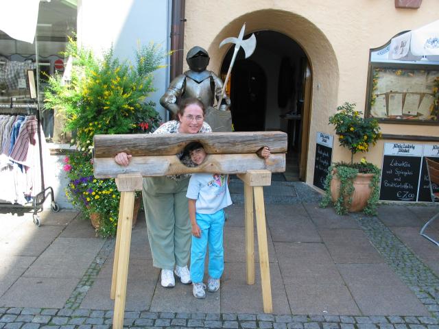 Pat and Xandie are punished in the stocks outside our hotel in
Fssen.  (Both have hands so small that they could insert them
without lifting the upper bar.)