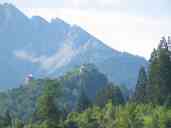 The Ehrenberg ruins, seen from a street in Reutte-in-Tirol, Austria,
which is the town nearest the ruins.  Note the incongruity of the two
buildings with conical roofs, which have been rebuilt to immaculate
perfection.  By the way, we had already walked about half a mile to
get to the spot where I took this picture, and we got to the ruins by
walking further.  It was definitely good exercise.
