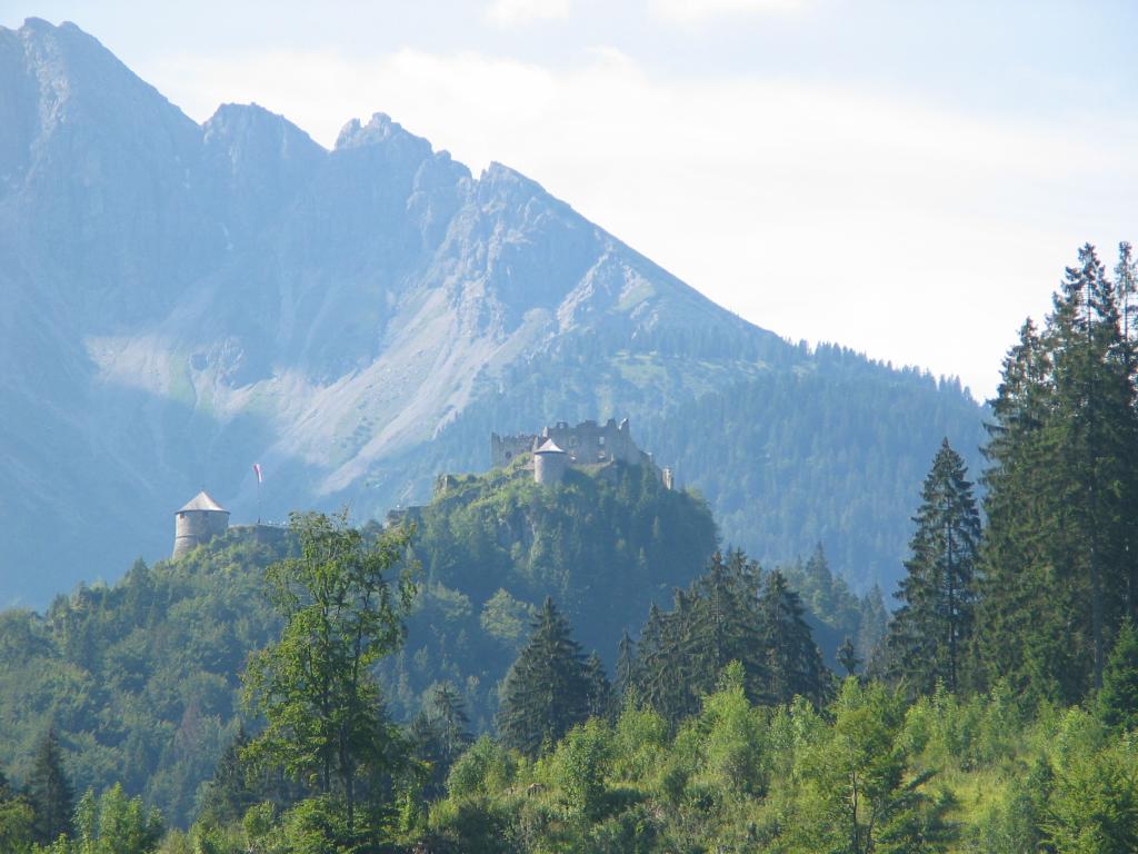 The Ehrenberg ruins, seen from a street in Reutte-in-Tirol, Austria,
which is the town nearest the ruins.  Note the incongruity of the two
buildings with conical roofs, which have been rebuilt to immaculate
perfection.  By the way, we had already walked about half a mile to
get to the spot where I took this picture, and we got to the ruins by
walking further.  It was definitely good exercise.