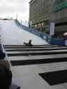 A worker finishes the first sled run down the artificial hill in Essen.