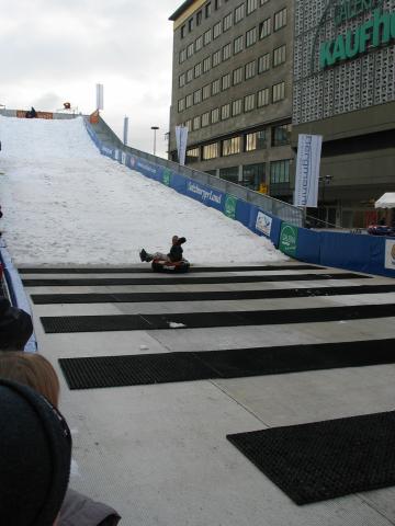 A worker finishes the first sled run down the artificial hill in Essen.