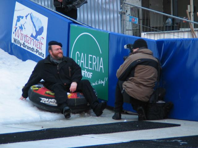 The mayor of Essen poses for a faked photograph of himself "going down" the artificial sledding hill.