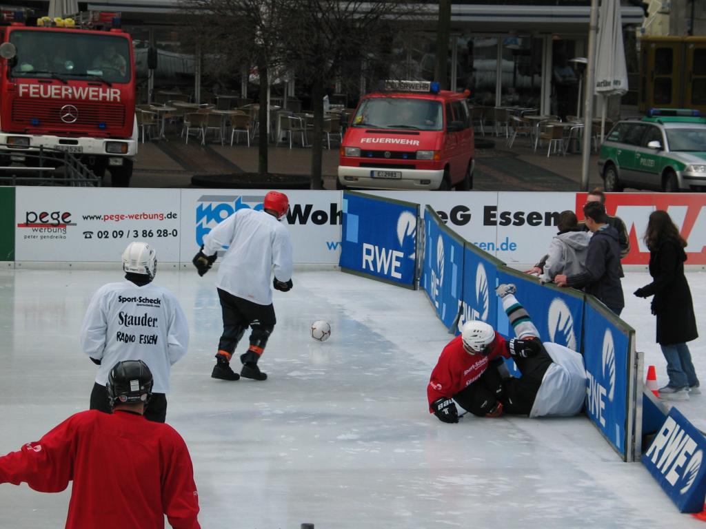 Ice soccer in Essen.  1/3 of the outdoor skating rink (itself slightly smaller than a pro hockey rink) was blocked off for this goofy and dangerous game.  Note the fire trucks in the background; the red team was from the fire department, and when they finally scored a goal the firemen in the trucks set off their lights and sirens.