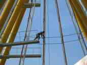 Disconnecting ribs.  This guy is removing the pins that hold
connecting rods.  As you can see, OSHA is nowhere to be found.  These
guys clamber all over, 75 feet up, carrying small sledgehammers, with
no harnesses or safety lines of any kind.  They drive out connecting
pins that weigh 10-20 pounds, yet nobody wears a hard hat.  If
something slips, so does he!