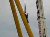 Connecting the crane to the support beam.  Note the purpose-built
connection point (only on this beam; the other is connected nearer the
hinge) and the built-in steps that allow the worker to get to that
point.