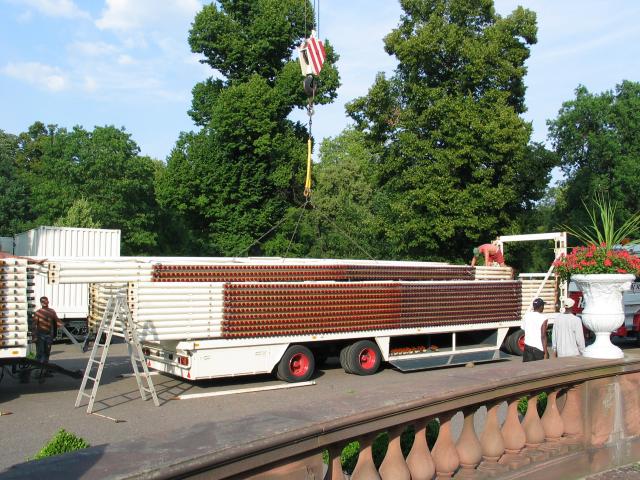 Stacking the ribs on the truck.  The crane re-lifts, and the man in
front muscles the ribs into position, where they are bolted into
place.