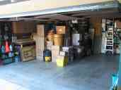 Our fully packed garage, with car space reserved.  When we returned
four days later, all of the remaining space up to the taped line had
been taken over by our tenants.