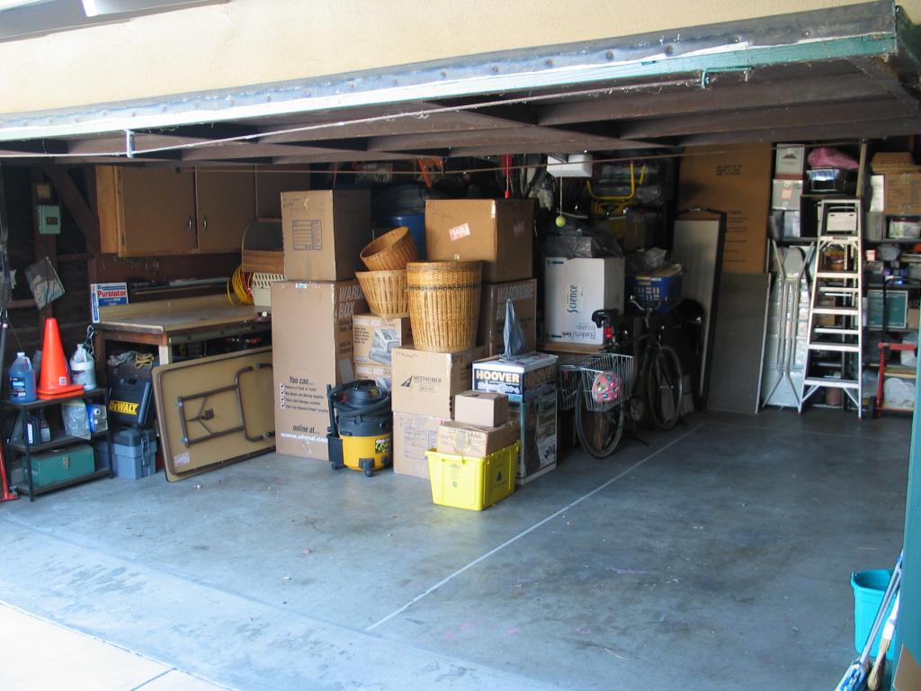 Our fully packed garage, with car space reserved.  When we returned
four days later, all of the remaining space up to the taped line had
been taken over by our tenants.