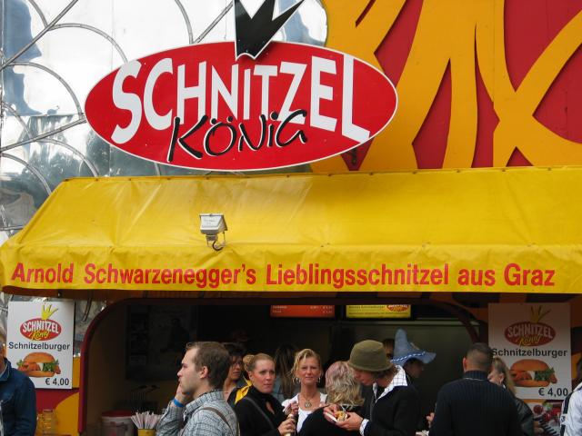 A schnitzel stand at Oktoberfest.  The sign translates as "Arnold Schwarzenegger's favorite schnitzel from Graz" (Graz is Arnold's home town in Austria).  Since Schwarzenegger had been governor of California for less than a year, we felt obligated to send this picture to Steve Harvey of the LA Times, who printed it the next day.