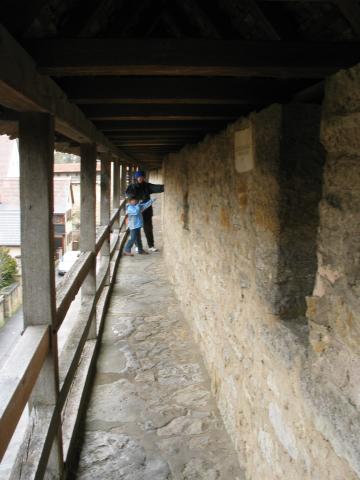 Xandie and Pat check out an archer's port in the Rothenburg wall.