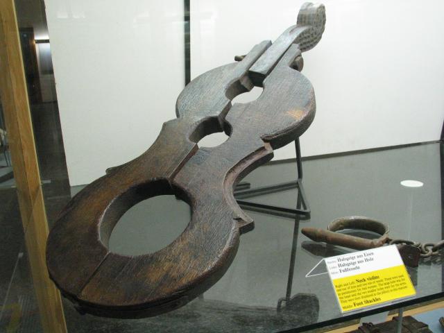 A "neck violin" in the Rothenburg Medieval Crime Museum.  This was a sort of portable stock.  The large hole was placed around the offender's neck, and the small holes held his or her hands.  I didn't photograph the "double neck violin," which was normally used to lock two quarreling women together until they made peace.