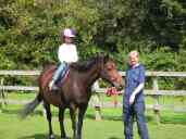 Xandie riding her first real horse at Horse World.