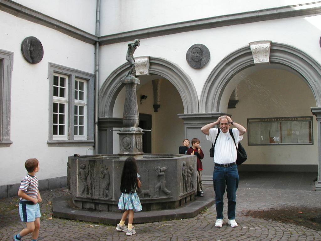 Geoff gets spat upon by the "naughty spitting boy" fountain in
Koblenz, which is a symbol of the city.  Photo by Pat using Xandie's
camera.