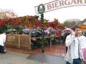 Rain never interferes with celebrations in Germany.  Here, revelers
sit in an Oktoberfest Biergarten, umbrellas up, drinking away.
Waiters with squeegees and towels would appear to dry off benches as
needed.