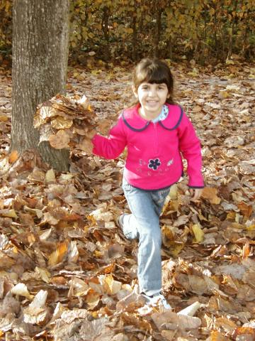 Xandie throwing leaves at Mommy.