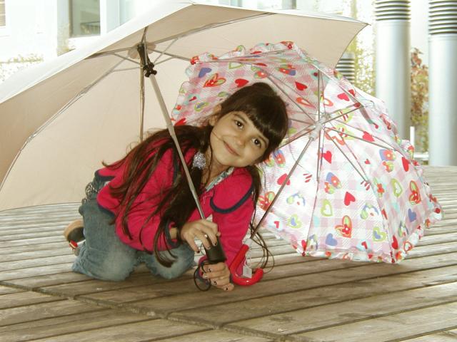 Xandie playing with her and Mommy's umbrellas.