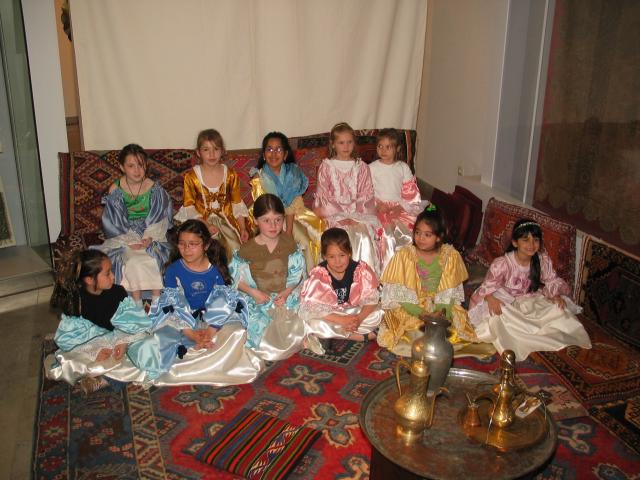 Xandie and her friends sit for "tea" in their dress-up outfits at Xandie's birthday party.  L to R, front row: Laura, Vivian, Fleur, Isobel, Kathy, Xandie.  Back row: Isla, Katherine, Sonakshi, Valerie, Aime.