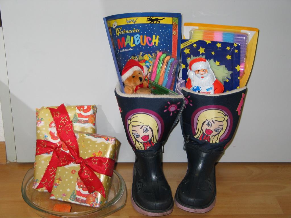 Xandie's boots just after St. Nikolaus filled them up.  It seems there wasn't quite enough room, so after feeding his donkey he put some extra presents in the dish that had held the carrots and oats.