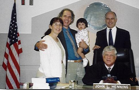 With family and judge in adoption court