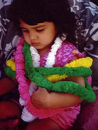 Wearing 5 plastic leis