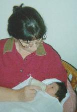 Mom feeding Alexandra a bottle