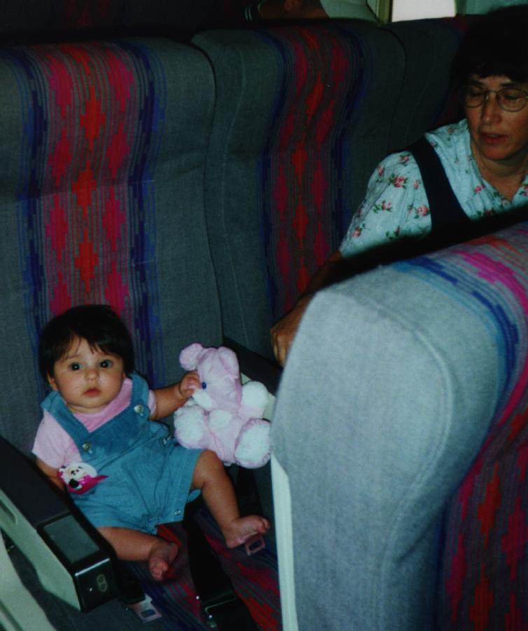 On the airplane with Mommy and her favorite teddy bear