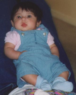 With hands in coverall pockets