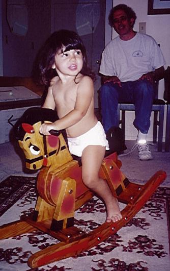 Riding her old/new rocking horse