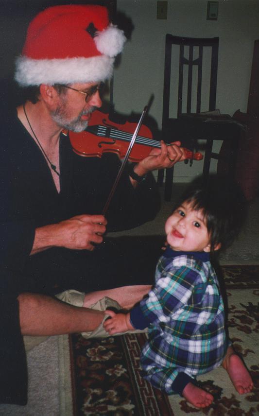 Watching Daddy with her new violin