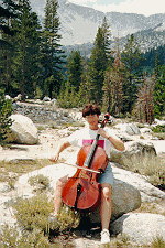 Picture of Pat playing cello in the mountains
